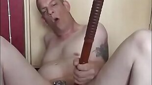 naked bisexual guy self fucks himself with a dildo on a bid while locked in a Chastity device